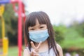 Asian child girl smiling and wearing face mask Royalty Free Stock Photo